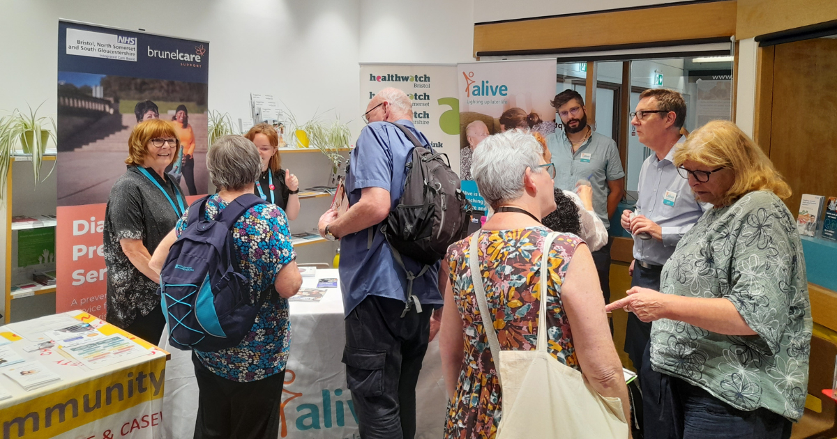 People looking at information about dementia on tables and stalls.