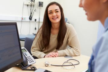 A teenager talking to a school nurse