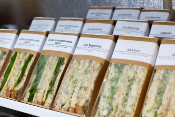 A line of packaged sandwiches.