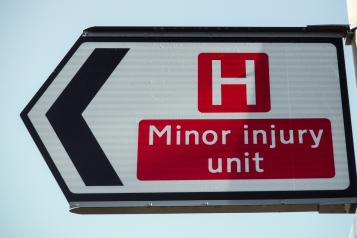 Minor injury unit' on a road sign.