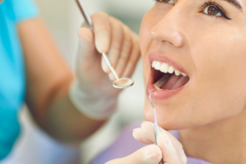 A white woman receiving dental treatment