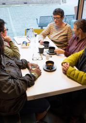 A group of women sitting around a table in a cafe